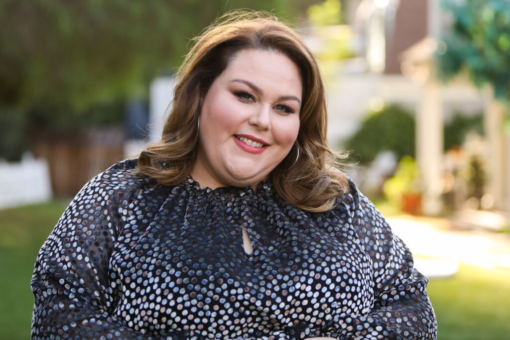 Chrissy Metz sitting in the park talking about her struggles with the weight loss